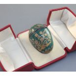 A silver mounted enamel 'egg' bonbonniêre, French, mid 18th century, decorated in raised gilding