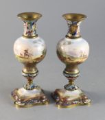 A pair of early 20th century French champleve enamel and porcelain candlesticks decorated with arabs