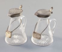 Two Edwardian silver mounted glass whisky flagons, Hukin & Heath, Birmingham, 1902 & 1906,with