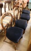 A set of four Victorian walnut balloon back dining chairs