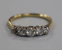 An 18ct gold and platinum, four (ex 5) stone diamond half hoop ring, size P/Q.