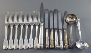 A set of seven George III silver fiddle, thread and shell pattern silver table forks, engraved