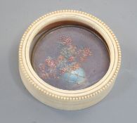 An ivory boite à miniature, c.1920, circular with beaded border, the lid inset with a miniature