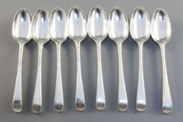 A set of eight George III silver feather edge pattern dessert spoons, monogrammed William and Thomas