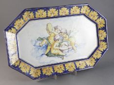 An F. Blondin Nevers faience canted rectangular platter, late 19th century, painted with cherub