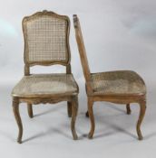A set of four 19th century French carved beech salon chairs with caned backs and seats H.3ft.
