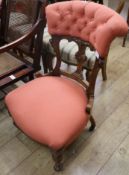 An Edwardian carved walnut nursing chair