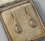 A pair of gold and diamond set oval earrings.