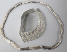 A contemporary silver 'feather' necklace and matching bracelet.