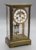 A Victorian brass four glass mantel clock, with mercury pendulum and R & Cie movement, height 30cm