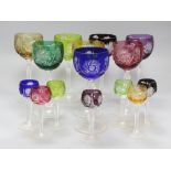 A set of eight harlequin set of colour flashes hock glasses and eight liqueurs, height 19cm
