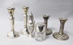 Two pairs of silver candlesticks and pepperette and silver mounted salts bottle