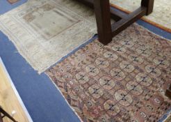 A Bokhara red ground rug and two Persian rugs (worn)