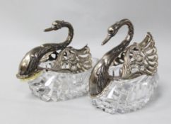 A pair of 1980's repousse silver mounted cut glass sweetmeat dishes modelled as swans, import