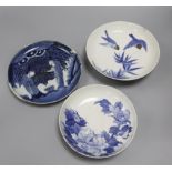 Three Nabeshima style blue and white dishes, figural dish diameter 21cm