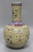 A Canton enamelled bottle vase, decorated flowers, foliate scrolls and Chinese characters on a