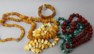 Two amber necklaces and a bracelet and two other necklaces.