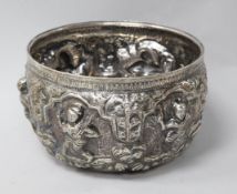A Burmese repousse white metal bowl, decorated with deities, height 9cm.