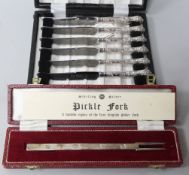 A set of six silver handled tea knives and a modern silver pickle fork.