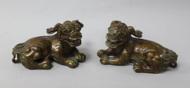 A pair of Chinese bronze lion-dog figures