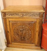 A carved oak cupboard W.92cm