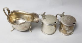 A pair of George V silver mustard pots by William Comyns & Sons, London, 1929, with blue glass