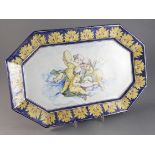 An F. Blondin Nevers faience canted rectangular platter, late 19th century, painted with cherub