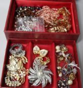 A box of mixed costume jewellery including an amethyst ring.
