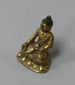 A Tibetan miniature gilt bronze seated figure of Buddha Shakyamuni