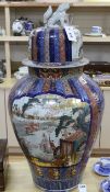 A large Japanese Imari fluted vase and cover, late 19th century, painted to each side with figures