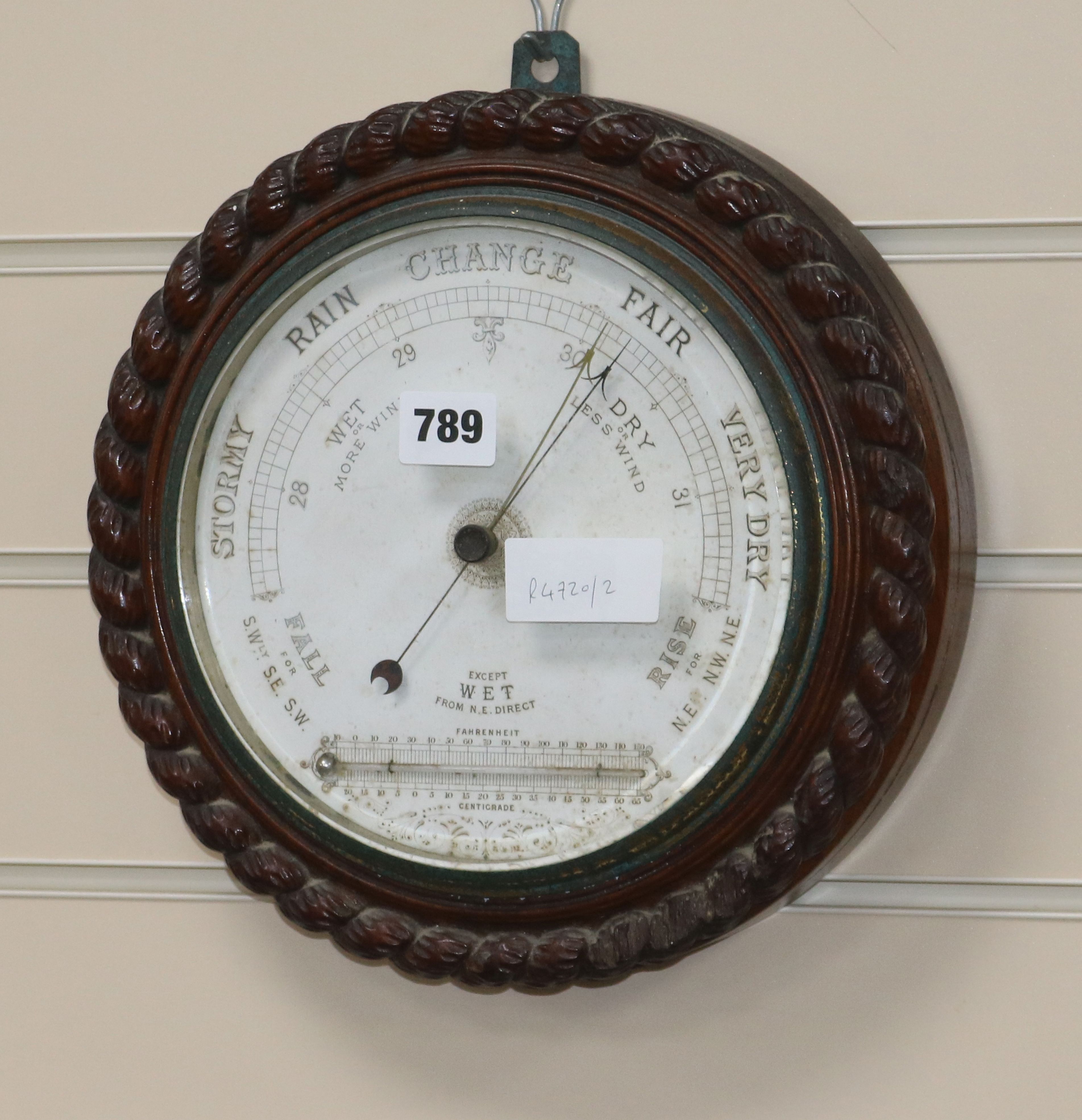 An Edwardian oak aneroid barometer W.28cm