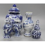 An Asian blue and white inverted pyriform jar and cover, a similar pair of smaller vases and two