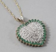 A 9ct gold, emerald and diamond set heart shaped pendant, on a 9ct gold fine link chain, pendant