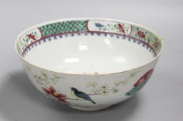 A Chinese Chien Lung famille verte bowl, decorated with birds, flowers and a central phoenix,