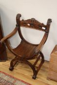 A 19th century carved walnut Savanarola elbow chair W.59cm