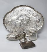 A George V silver dressing table tray, a cigarette case, a dwarf candlestick and two toilet jars.