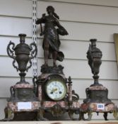 A late 19th century French spelter and rouge marble three piece clock garniture