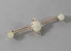 A gold, white opal and diamond set bar brooch, 51mm.