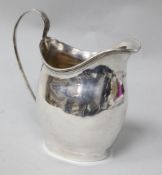 A George III silver cream jug by Peter & Ann Bateman, London, 1799, 12cm.