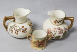 A pair of Royal Worcester blush ewers and a loving cup