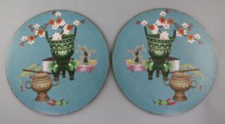 A pair of Chinese cloisonne table insets, 19th/20th century, decorated with Antiques, on a blue