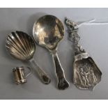 A Georgian silver caddy spoon, two later caddy spoons and a miniature mug.