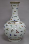 A Chinese famille rose bottle vase, Guangxu mark but later, painted with butterflies within