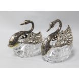 A pair of 1980's repousse silver mounted cut glass sweetmeat dishes modelled as swans, import