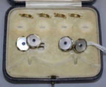 A pair of 18ct and 9ct gold, mother of pearl and gem set cufflinks.