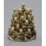 A Japanese ivory netsuke of multiple rakan, Meiji period, the underside carved as clouds inset