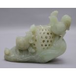 A Chinese celadon jade censer, carved as chickens and chicks beside a basket, on a rock work base,