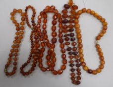 Five assorted amber necklaces.