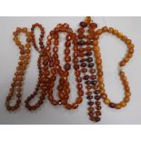 Five assorted amber necklaces.