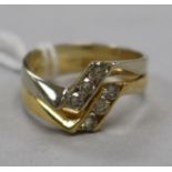 A two colour 18ct gold and six stone diamond ring, size O.